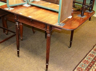 Lot 1324 - A 19th century mahogany drop leaf table of reeded legs