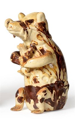 Lot 37 - A Slipware Model of a Seated Bear, 19th century, modelled seated holding a dog in its front...