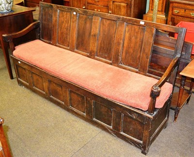 Lot 1349 - An 18th century panelled oak box settle