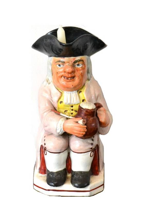 Lot 39 - A Staffordshire Pearlware Ruddy-Faced Toby Jug, early 19th century, wearing a black hat and...
