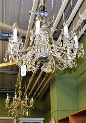 Lot 1372 - A glass chandelier with decorative drops and lustres and another similar