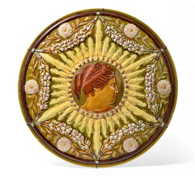 Lot 48 - 2032 A Linthorpe Pottery Charger, moulded with the profile of a maiden in a sun burst surrounded by