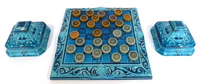 Lot 57 - A Leeds Fireclay Co. Ltd Draughts Board and Twenty-Eight Draughts Pieces, the board moulded...