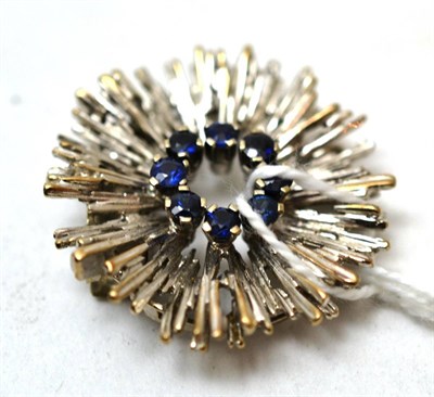 Lot 96 - A sapphire set 'sun burst' clasp, stamped '750'