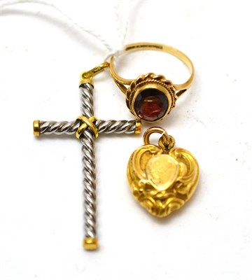 Lot 122 - A 9ct gold garnet ring, a cross stamped '750' and a heart shaped locket