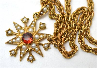 Lot 130 - A garnet and split pearl star pendant, stamped '9CT', on a fancy link chain