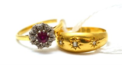 Lot 133 - An 18ct gold diamond three stone ring and a cluster ring (2)