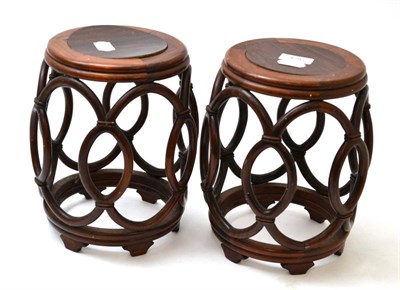 Lot 136 - Pair of Chinese hardwood small barrel shaped stands