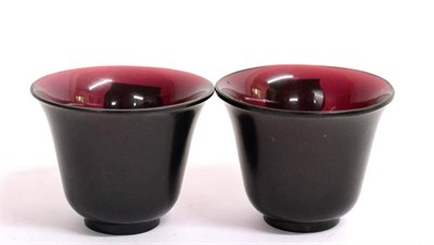 Lot 68 - A Pair of Peking Manganese Glass Tea Bowls, Qing Dynasty, of ovoid form with slightly everted rims