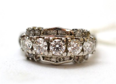 Lot 195 - Five stone diamond ring graduating round brilliant cut diamonds, bordered by two rows of diamonds