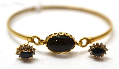 Lot 205 - A 9ct gold stone set bangle and a pair of 9ct gold sapphire and diamond cluster earrings