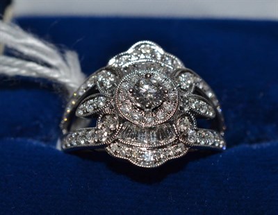 Lot 227 - Diamond cluster ring, the round brilliant cut and baguette cut diamonds, grain and claw set mounted