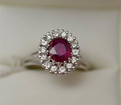 Lot 234 - Ruby diamond cluster ring, the round brilliant cut diamond claw set in 18ct white gold