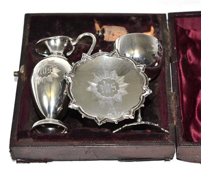 Lot 252 - A cased silver Communion set comprising chalice, paten, ewer and a stopper (different maker to...