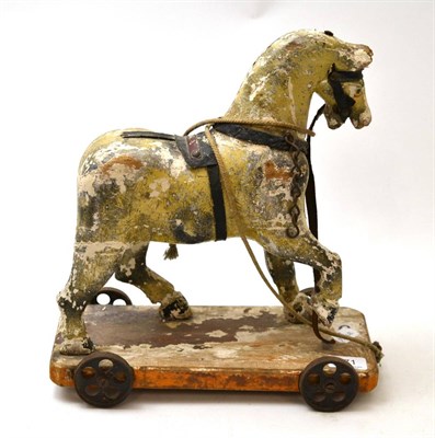 Lot 271 - Carved 19th century pull along polychrome horse on rectangular stand with wheels