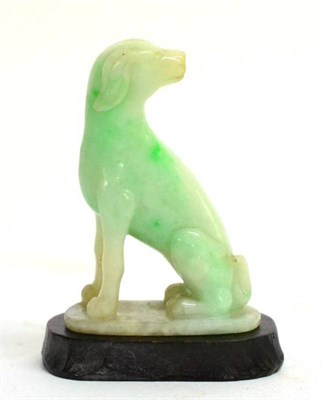 Lot 84 - A Chinese Green Jadeite Figure of a Hound, 19th century, seated looking back on an oval base,...