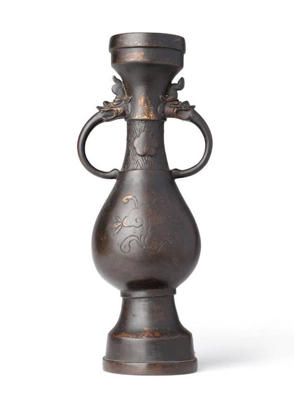 Lot 85 - A Chinese Bronze Vase, possibly Ming Dynasty, of Hu form cast with dragon's mask and scroll...