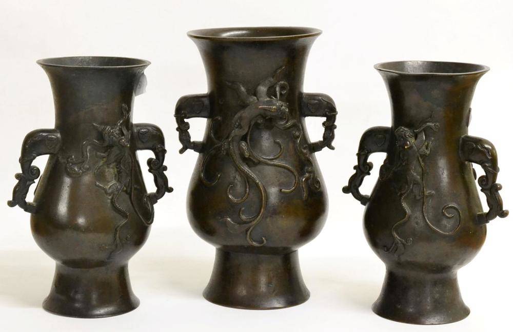 Lot 87 - A Garniture of Three Chinese Bronze Vases, bears Xuande reign mark, of flattened baluster form with