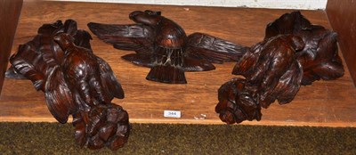 Lot 344 - A pair of carved wooden wall brackets and a carved wooden eagle