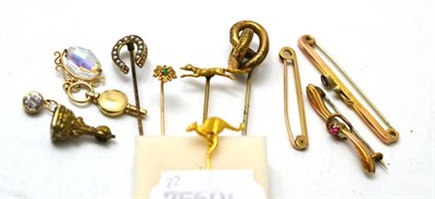 Lot 389 - A group of stick pins, bar brooches and charms