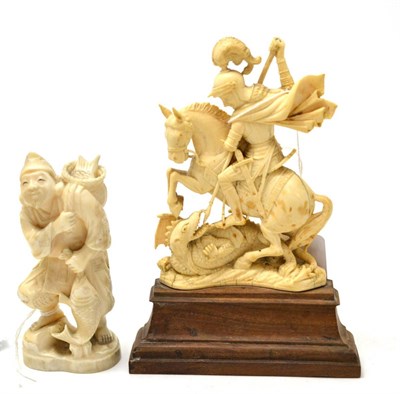 Lot 414 - A 19th century Japanese carved ivory figure of a fisherman and another of St George and the...