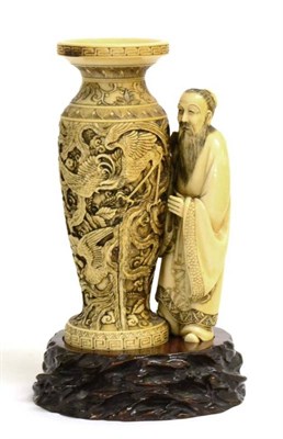 Lot 109 - A Japanese Ivory Okimono of a Man, Meiji period, the bearded figure wearing flowing robes...