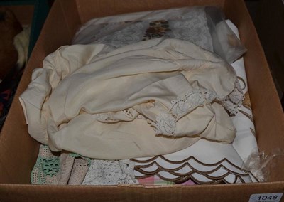 Lot 1048 - A group of textiles including a fur collar, camisole, cream silk bed jacket, night dress,...