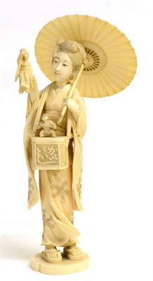 Lot 115 - A Japanese Ivory Okimono, Meiji period, as a girl wearing traditional dress holding a parasol...