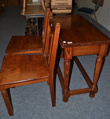 Lot 1124 - A pine table and two chairs