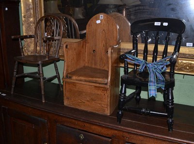 Lot 1299 - Carved oak child's commode chair with removable seat, child's wheel back chair and black...