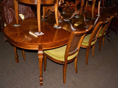 Lot 1319 - An extending D-end dining table and eight caned chairs