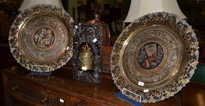 Lot 1334 - Two Egyptian mixed metal plaques and a dinner gong on carved wooden supports