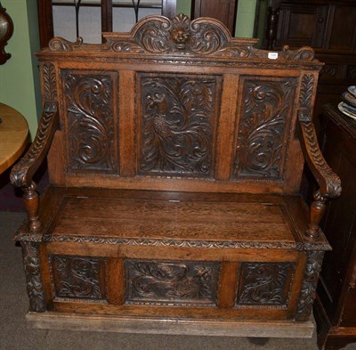 Lot 1345 - A carved oak monk's bench