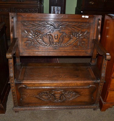 Lot 1347 - A carved oak monks bench