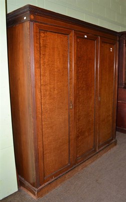 Lot 1407 - A mahogany and satinwood banded triple door wardrobe, 191cm wide