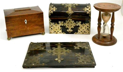 Lot 37 - An ebony veneered stationary box and a blotting pad with applied metal mounts, egg timer, tea caddy