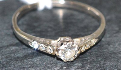 Lot 84 - A diamond solitaire ring, with stone set shoulders