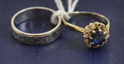 Lot 100 - An 18ct white gold band ring and a sapphire set cluster ring (a.f.)