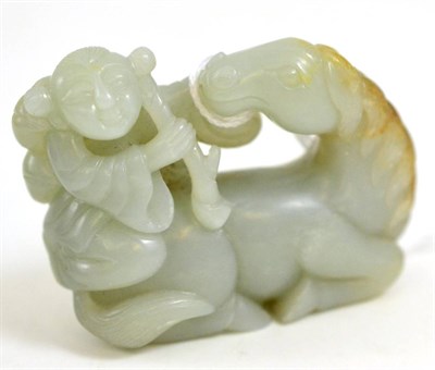 Lot 111 - A Chinese jade figure group, as a boy holding a fruiting branch sitting on the back of a...