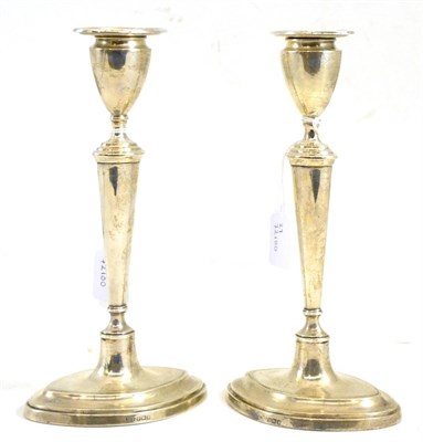 Lot 112 - A pair of silver candlesticks