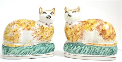 Lot 114 - Pair of Victorian pottery Staffordshire seated cats with sponged decoration