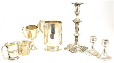 Lot 192 - Plated candlestick, pair of dwarf silver candlesticks, Christening can, trophy cup, '950'...