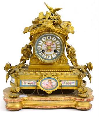 Lot 203 - A gilt metal and porcelain mounted mantel clock and giltwood stand