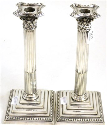 Lot 208 - A pair of silver plated Corinthian column candlesticks