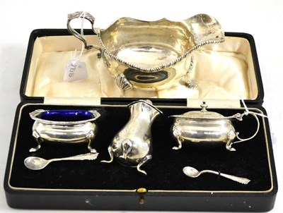 Lot 212 - Cased three piece silver cruet and George III style silver sauce boat (2)