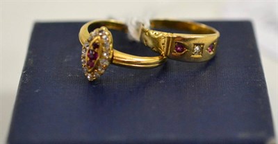 Lot 255 - An 18ct gold ruby and diamond marquise shaped ring and a diamond and ruby three stone ring (2)