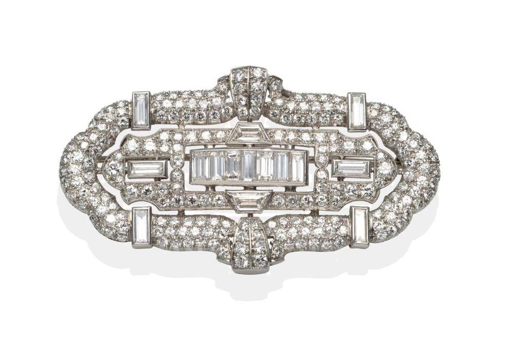 Lot 178 - A Diamond Plaque Brooch, seven baguette cut diamonds channel set centrally, pavé set with...