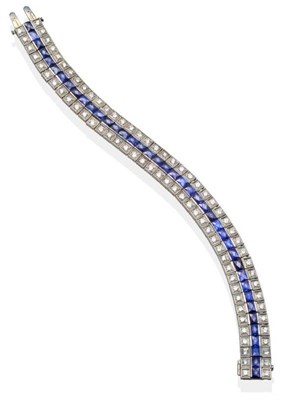 Lot 185 - A Synthetic Sapphire and Diamond Bracelet, set with calibré cut sapphires within two rows of...