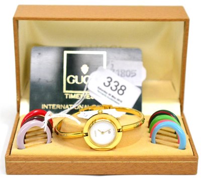 Lot 338 - A lady's interchangeable bezel wristwatch, signed Gucci, with box and eight multi-coloured bezels