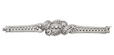 Lot 192 - A Diamond Bracelet, with a central undulating and swirling diamond cluster, to a three row...
